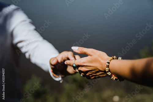 man and woman holding each other's hands, close-up, in nature, outdoors, hugs, tenderness