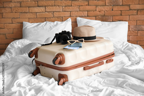 Packed suitcase on bed in room