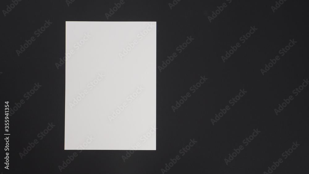 White empty space A4 paper put on black background. White empty space A4 paper put on black background.