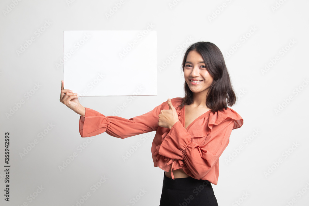 Young Asian woman show thumbs up with white blank sign . Young Asian woman show thumbs up with white blank sign .