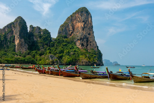 Thai traditional longtaile boats at Reilly beach in Krabi province. © SERGEY