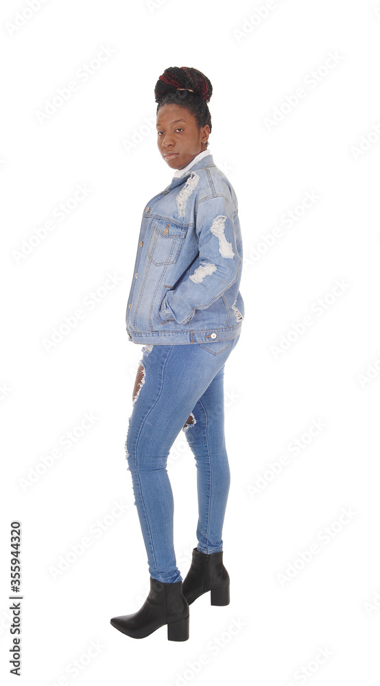 Beautiful African woman standing in jeans in the studio Beautiful African woman standing in jeans in the studio