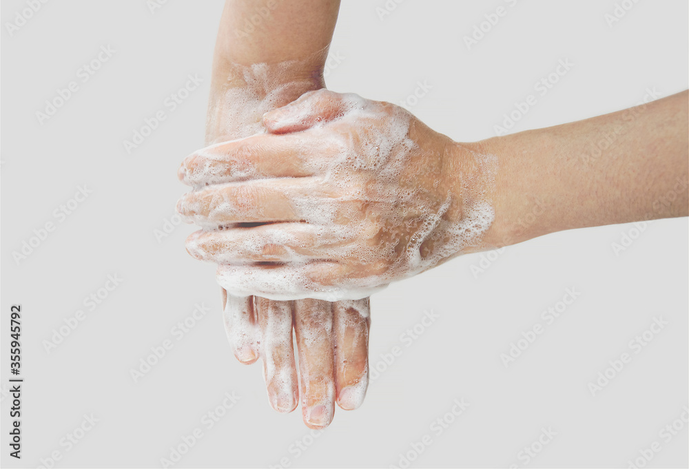 Fototapeta premium Woman washes hands with soap, hands in foam