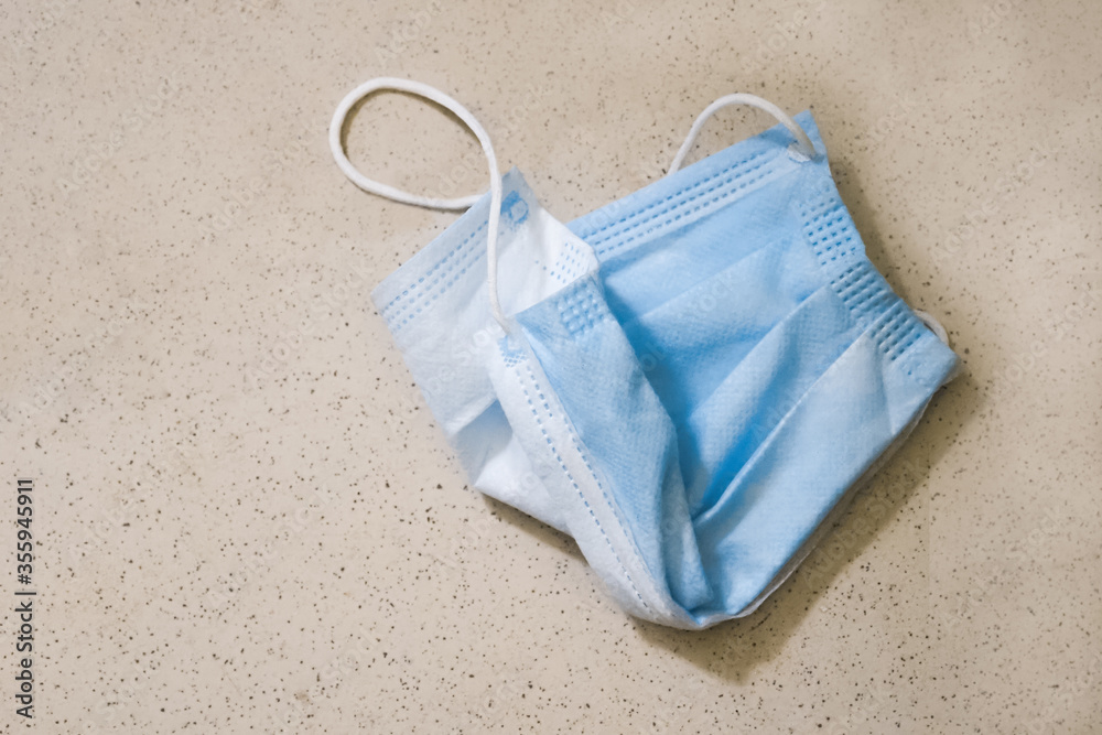 Medical face mask thrown on the floor Medical face mask thrown on the floor