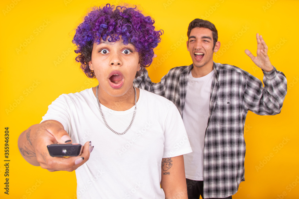 couple of man and woman arguing isolated with the television remote couple of man and woman arguing isolated with the television remote