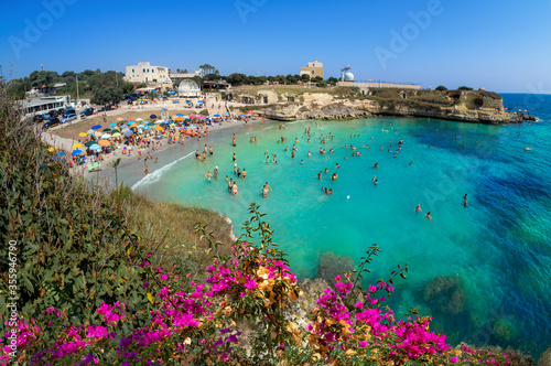 Baia dei Turchi beach in summer with people enjoying leisure activity on Lecce coast of Italy