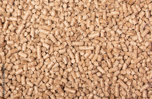 Texture of woody clumps, pellets of litter, for cat, rabbit, guinea pig, hamster, rodent, bird, turtle and other pets. Cat litter for a toilet close-up. Cat tray wooden photo