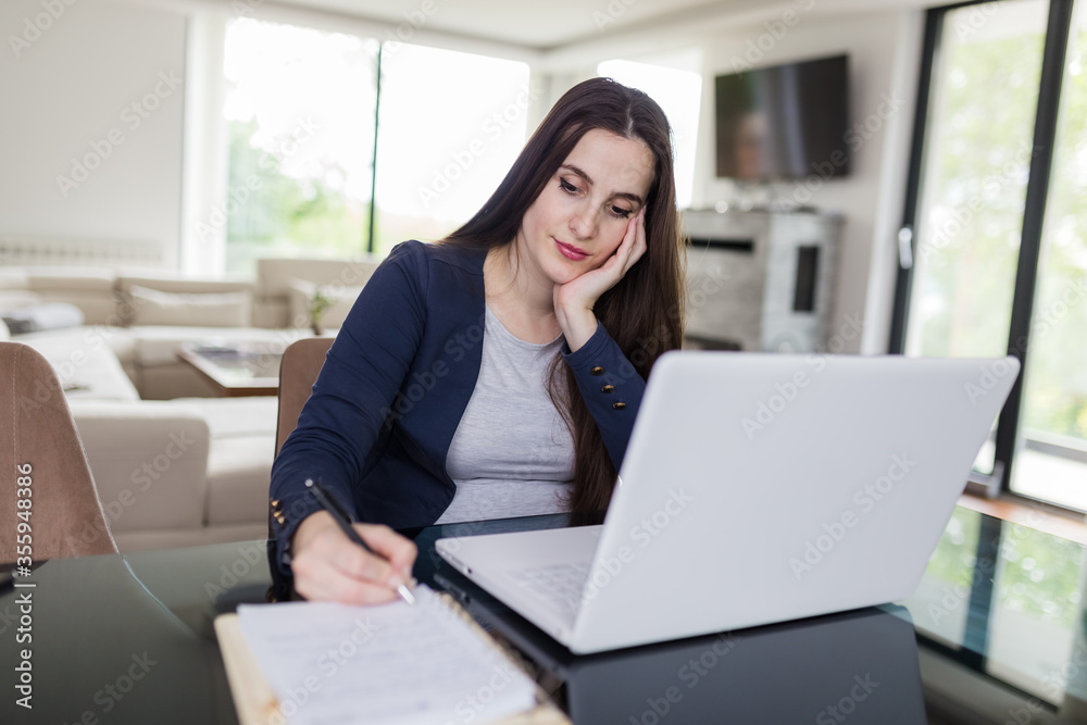Young woman working from home. Freelancer or online learning concept. Young woman working from home. Freelancer or online learning concept.
