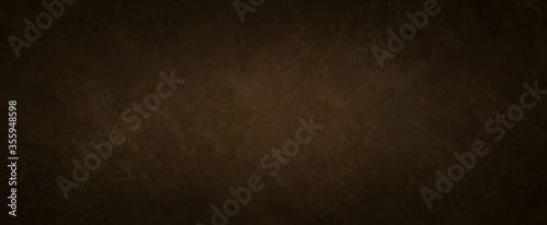 old brown background texture with black vignette in old vintage textured border design, dark elegant sepia color wall with light spotlight center photo