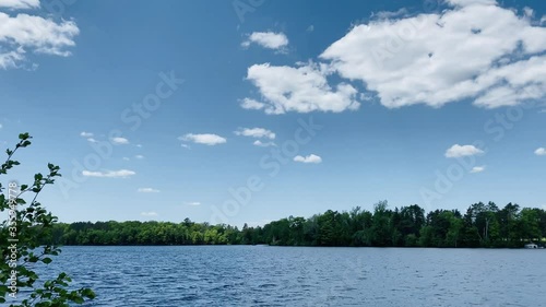Lake in Rhinelander WI with boat passing and swimmers photo