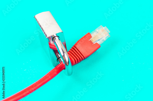 Lock on ethernet wire. Internet security concept in blue background