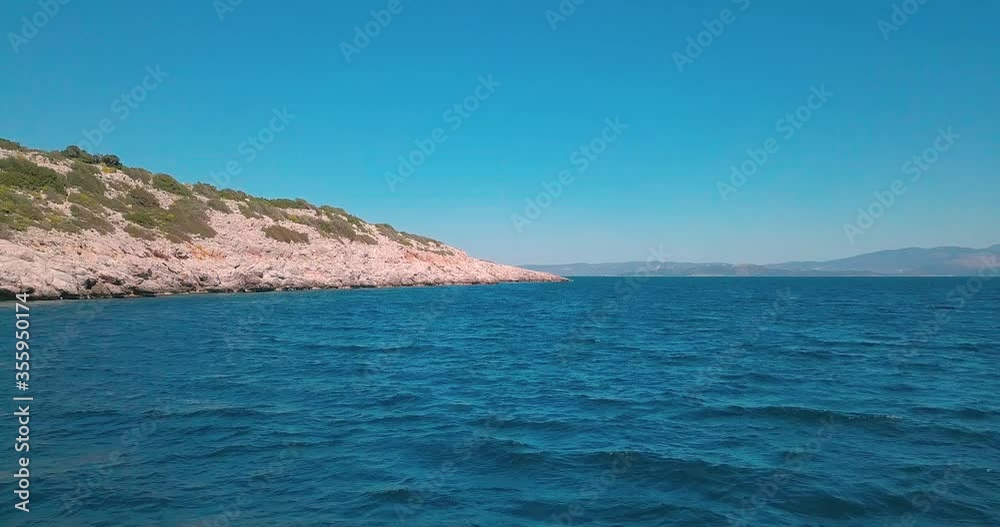 Forward aerial shot next to a rocky shore in the aegean sea, Greece. 4K video quality Forward aerial shot next to a rocky shore in the aegean sea, Greece. 4K video quality