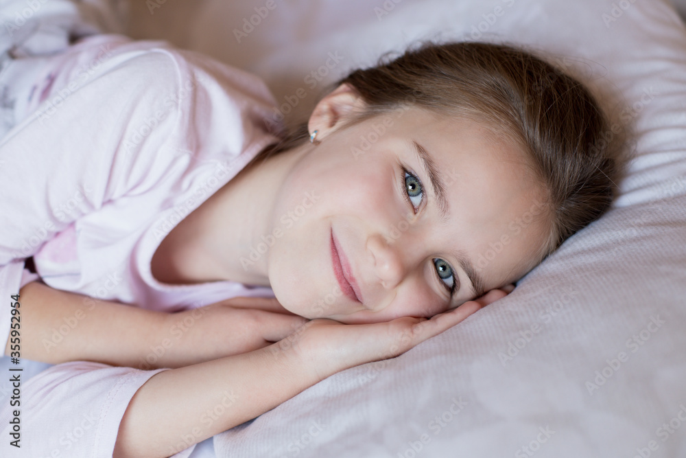 Cute little girl in bed woke up in the morning Cute little girl in bed woke up in the morning