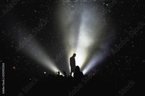 silhouette of a vocalist on stage and the effect of the starry sky. amazing show in the light of spotlights. concert for fans