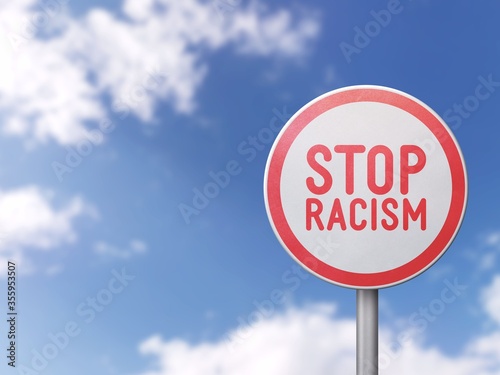 Stop racism - Road sign on blue sky background