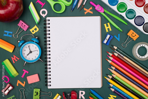Top above overhead view photo of blank notebook with colorful stationery isolated on greenboard