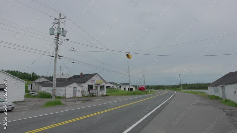 Isolated empty street with one street light daytime overcast Isolated empty street with one street light daytime overcast