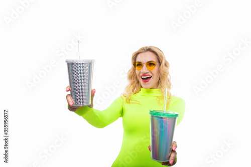 Sexy blonde in a bright dress posing with two cocktail glasses. Isolated