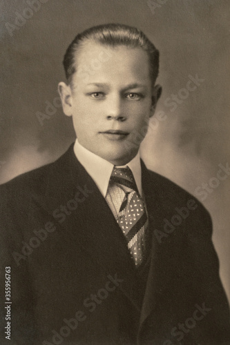 Germany - CIRCA 1930s: Man in suit portrait close up in studio Vintage art deco era photo