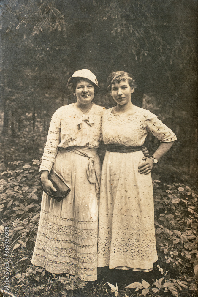 Latvia - CIRCA 1920s: Full body shot of two young women in forest. Vintage Carte de Viste Edwardian era photo Latvia - CIRCA 1920s: Full body shot of two young women in forest. Vintage Carte de Viste Edwardian era photo