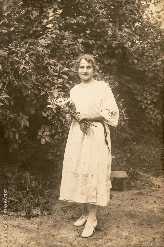 Latvia - CIRCA 1920s: Full body shot. Young women in garden. Vintage Carte de Viste Edwardian era photo