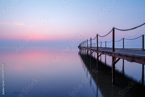 pier on the lake in the early morning photo