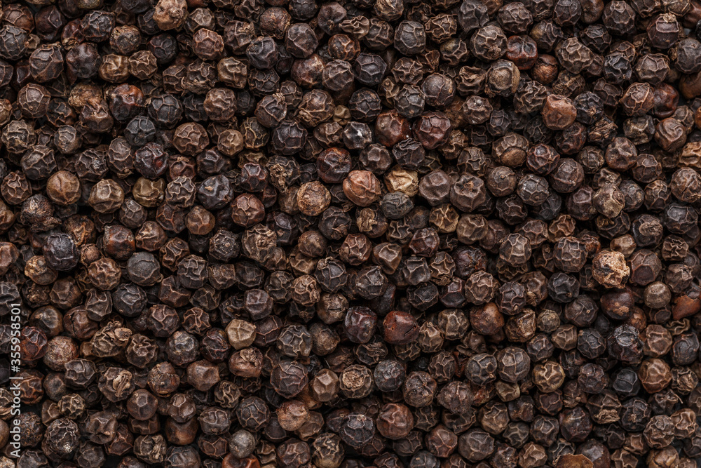 Peppercorn background. Dry black pepper seeds. Top view. Flat design. Macro spice background Peppercorn background. Dry black pepper seeds. Top view. Flat design. Macro spice background