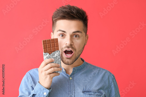 Surprised young man with ta...