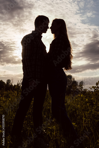 Loving couple in the field. Sunset.
