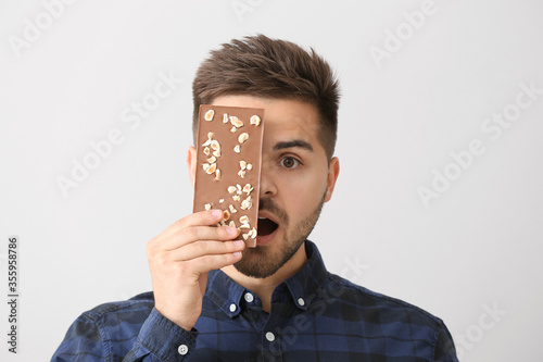 Surprised young man with ta...