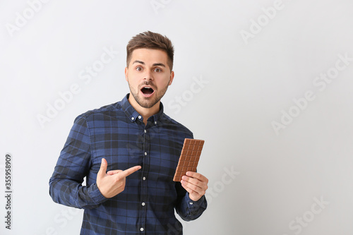 Surprised young man with ta...