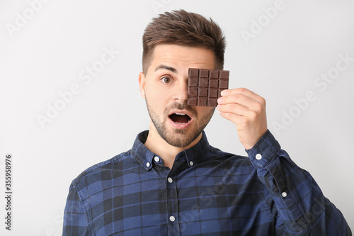 Surprised young man with ta...