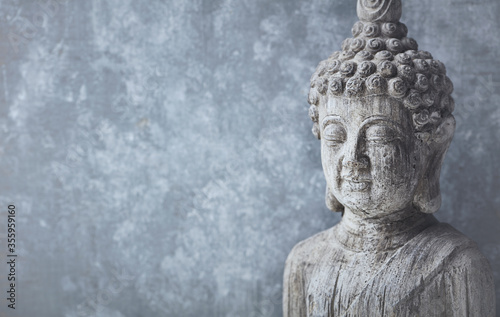 Meditating Buddha Statue on bright background. Copy space.