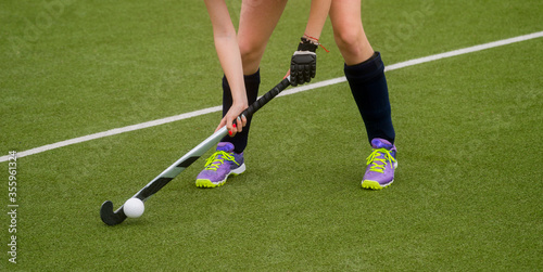 Field Hockey player, ready to pass the ball to a team mate. Hockey is a team game
