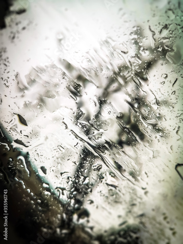 Waterdrops on the car window - blurred cityscape on the background