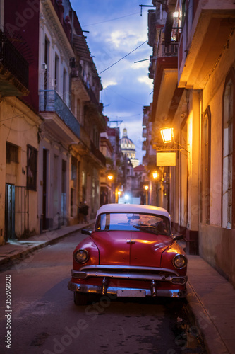 Amazing old american car on streets of Havana with Capitolio Building in background during night. Havana, Cuba. © danmir12