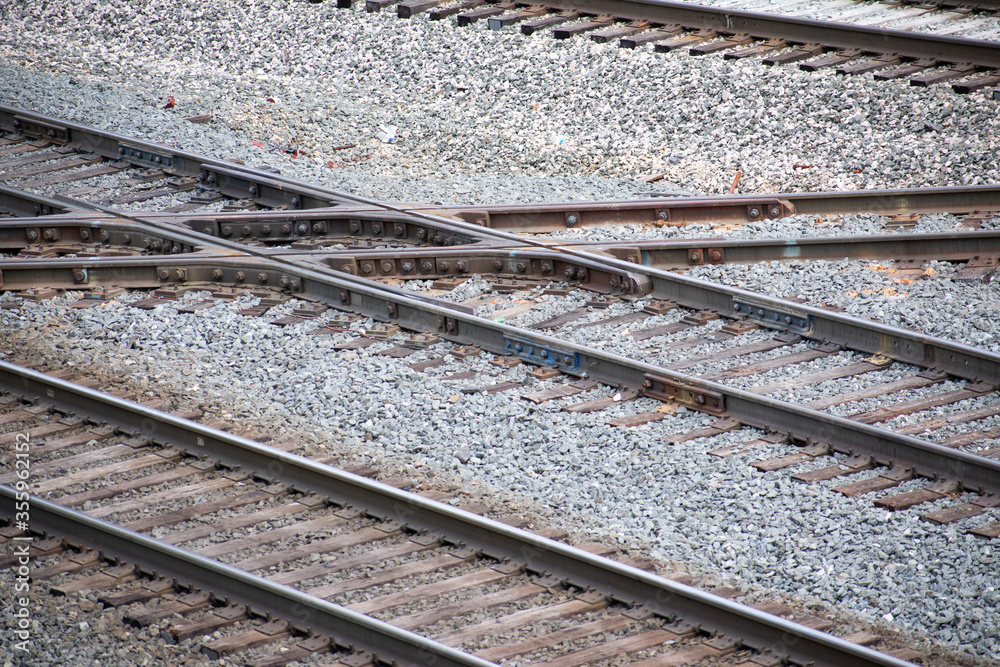 Train tracks intersecting on gravel for trains for transportation, shipping, cargo, and other aspects of the train industry and transit traffic and infrastructure. Train tracks intersecting on gravel for trains for transportation, shipping, cargo, and other aspects of the train industry and transit traffic and infrastructure.