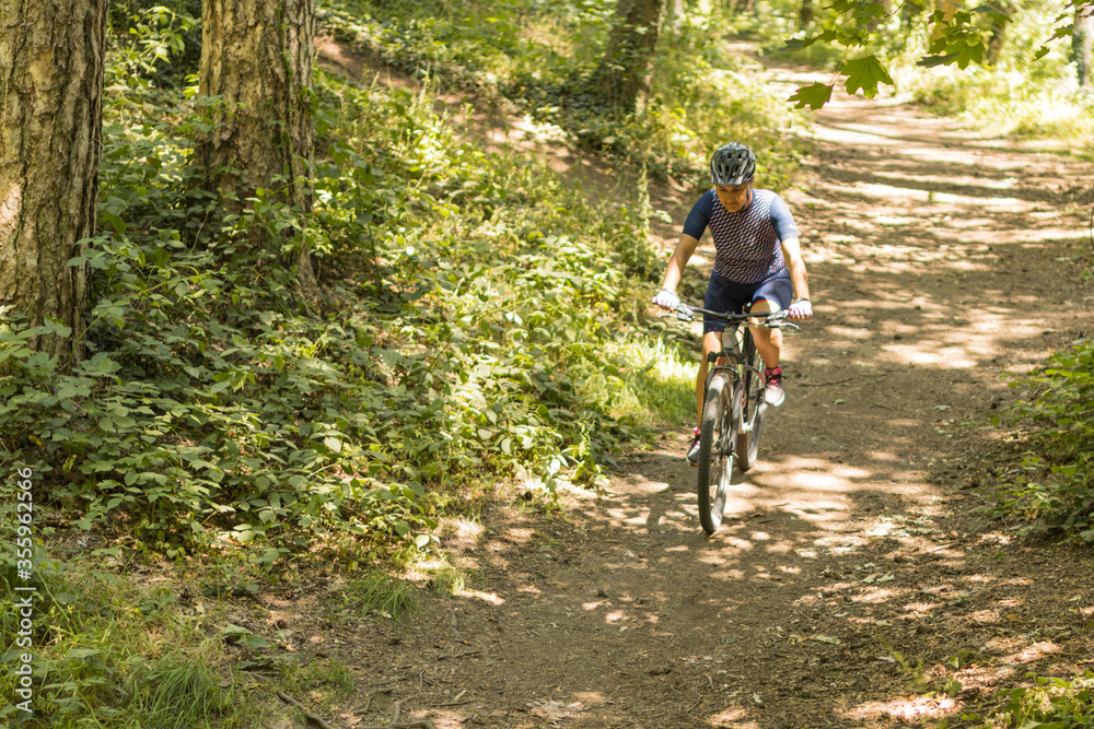 woman doing mountain biking among nature woman doing mountain biking among nature
