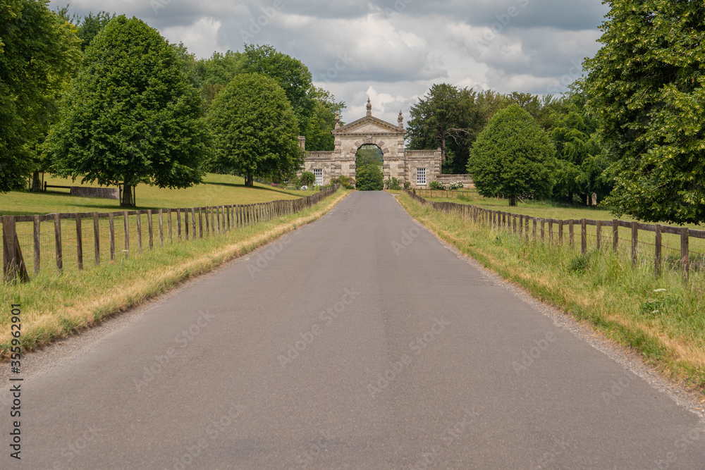 Ground level view leading up the road to the gates of the Fonthill Estate in Wiltshire near Hindon