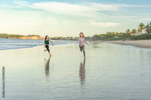 Children exercise running on the beach with drop shadow