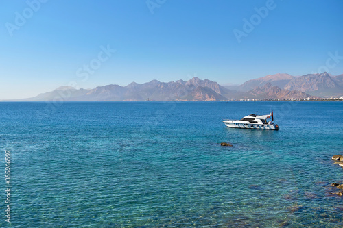 Yacht floating on the sea. Landscape with sea, mountain and yacht views. Beach holiday.