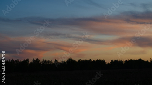 Beautiful sunset in the field. Dramatic sky. Evening sunset. Beautifully colored clouds at sunset.