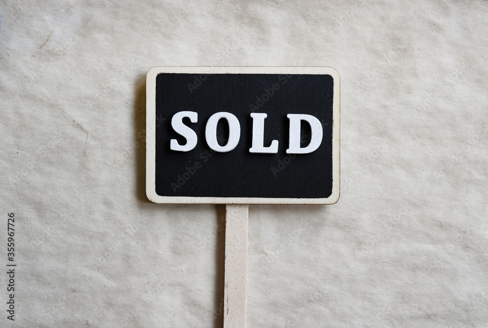Sold word on the chalkboard sign Sold word on the chalkboard sign