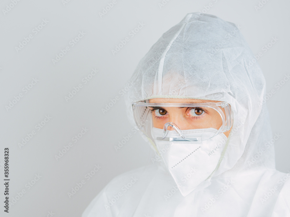 Caucasian woman doctor in uniform, medical cap and mask, close-up portrait.