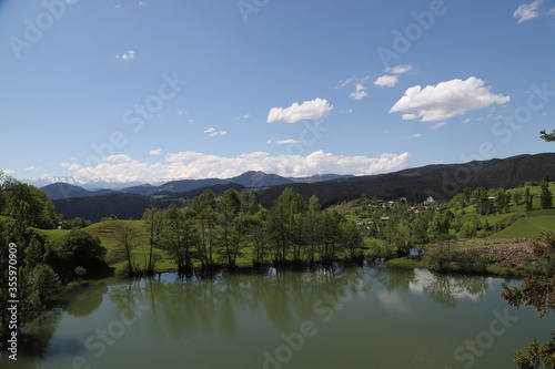Fototapeta Naklejka Na Ścianę i Meble -  Scenic panoramic landscape of a picturesque green mountain valley in spring. Historic village with blossoming trees and traditional houses.Savsat/ARTVİN/TURKEY