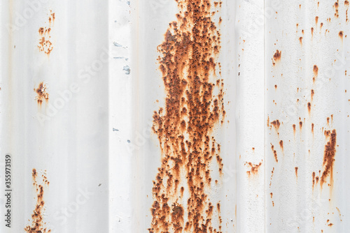 Red spots of rust on the white metal texture construction copy space for text title abstract