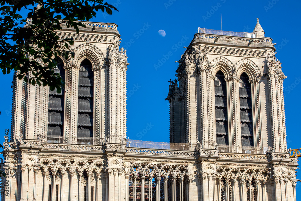 Paris, France - June 1, 2020: Beautiful view of the Notre-Dame Cathedral with a faint moon above it in Paris