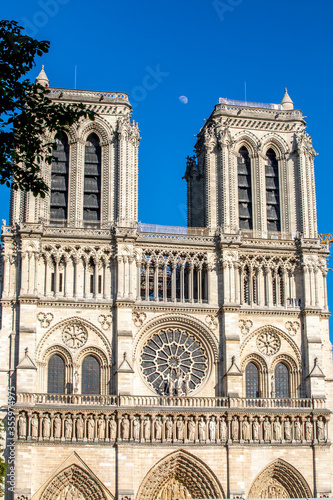Paris, France - June 1, 2020: Beautiful view of the Notre-Dame Cathedral with a faint moon above it in Paris