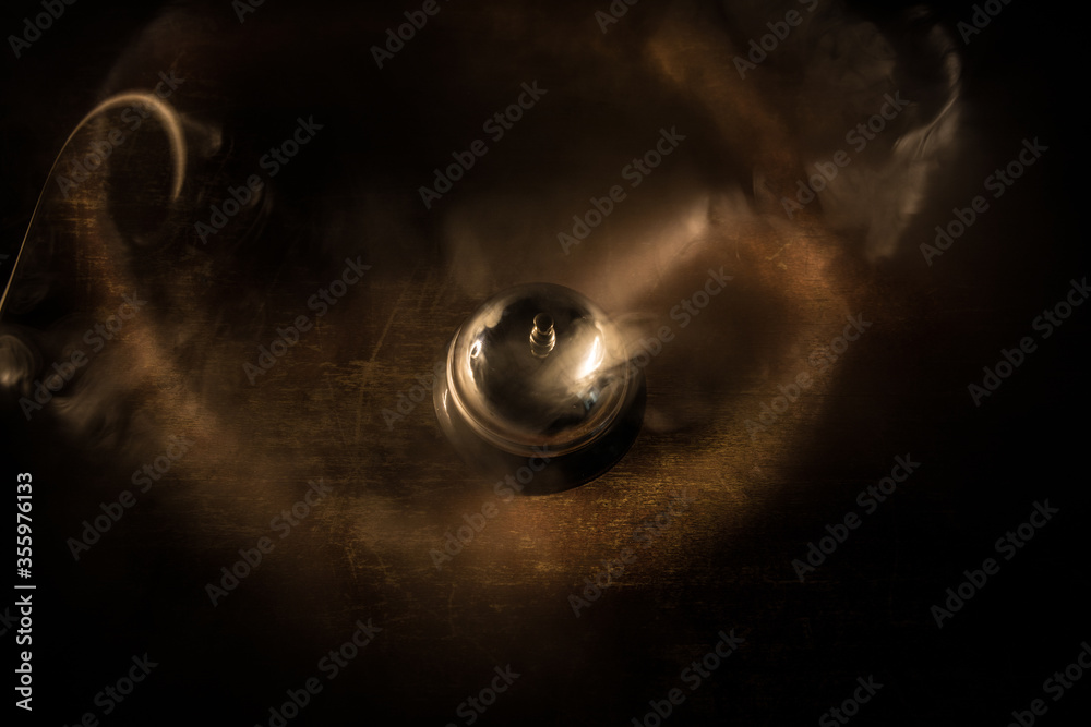 Hotel reception bell, service bell on the table, selective focus Hotel reception bell, service bell on the table, selective focus