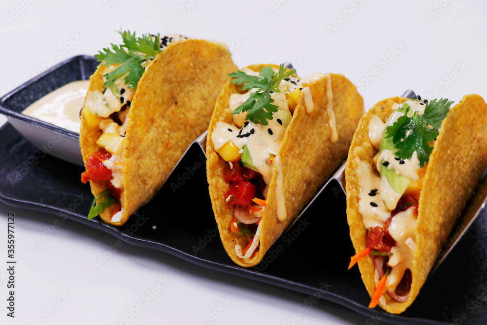 traditional Mexican dish taco,consisting of a small hand-sized corn or wheat tortilla topped with a filling
